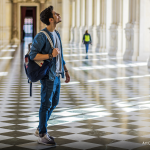 A man wandering through a museum.
