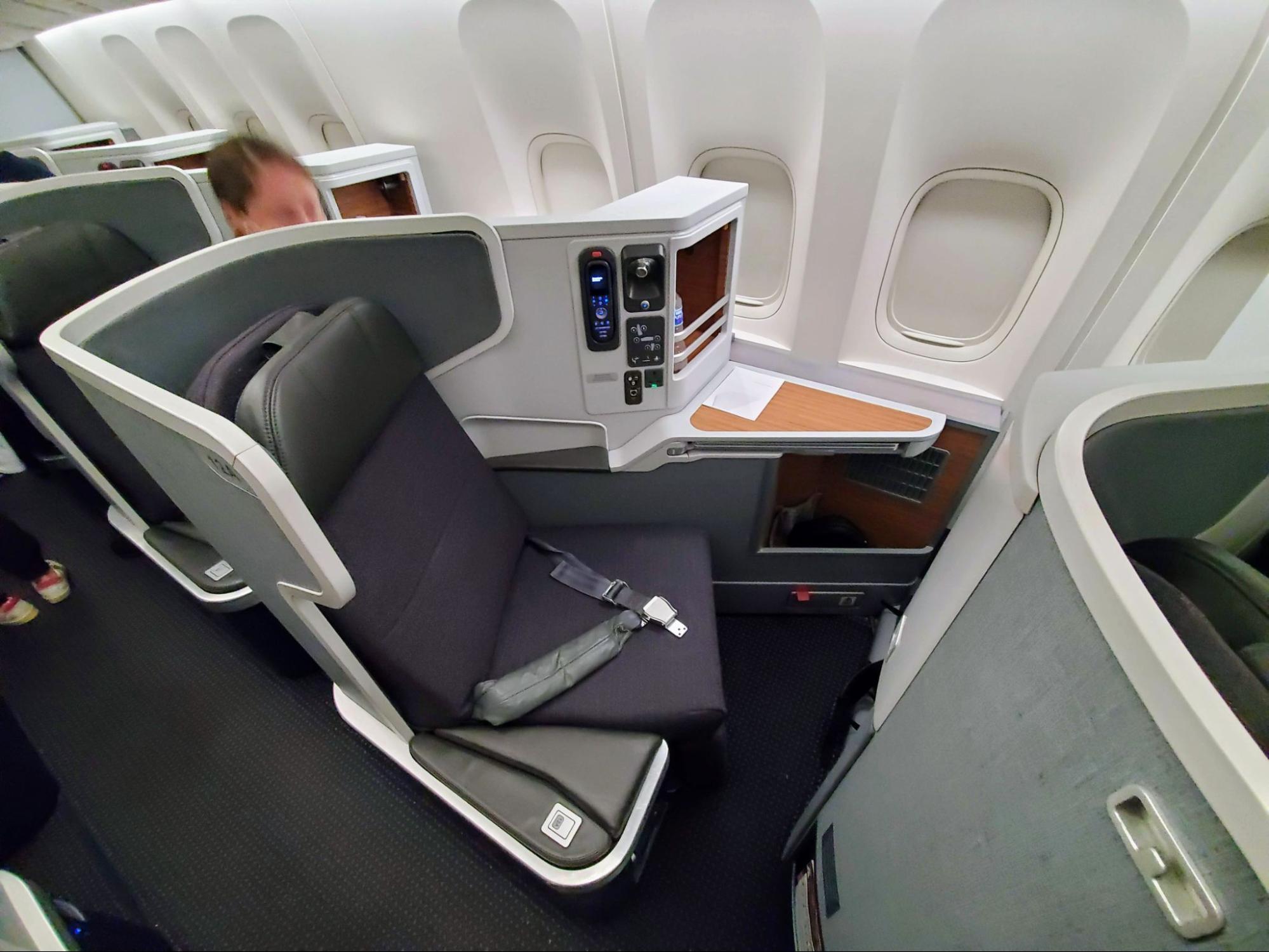 Photo of an American Airlines business-class seat next to the airplane window.