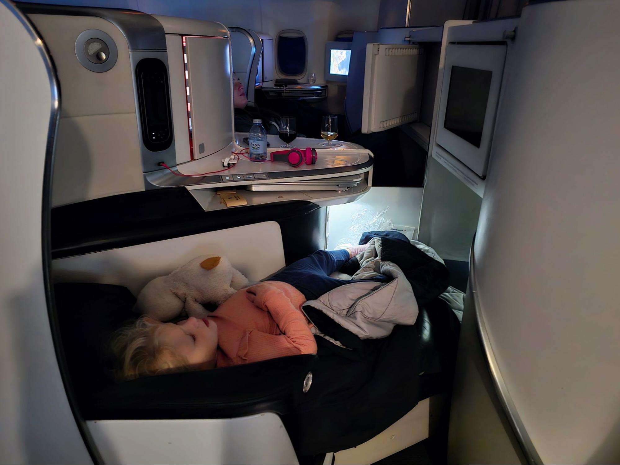 Image of writer Joseph Hostetler's daughter having a nap in a business-class seat on Air France.