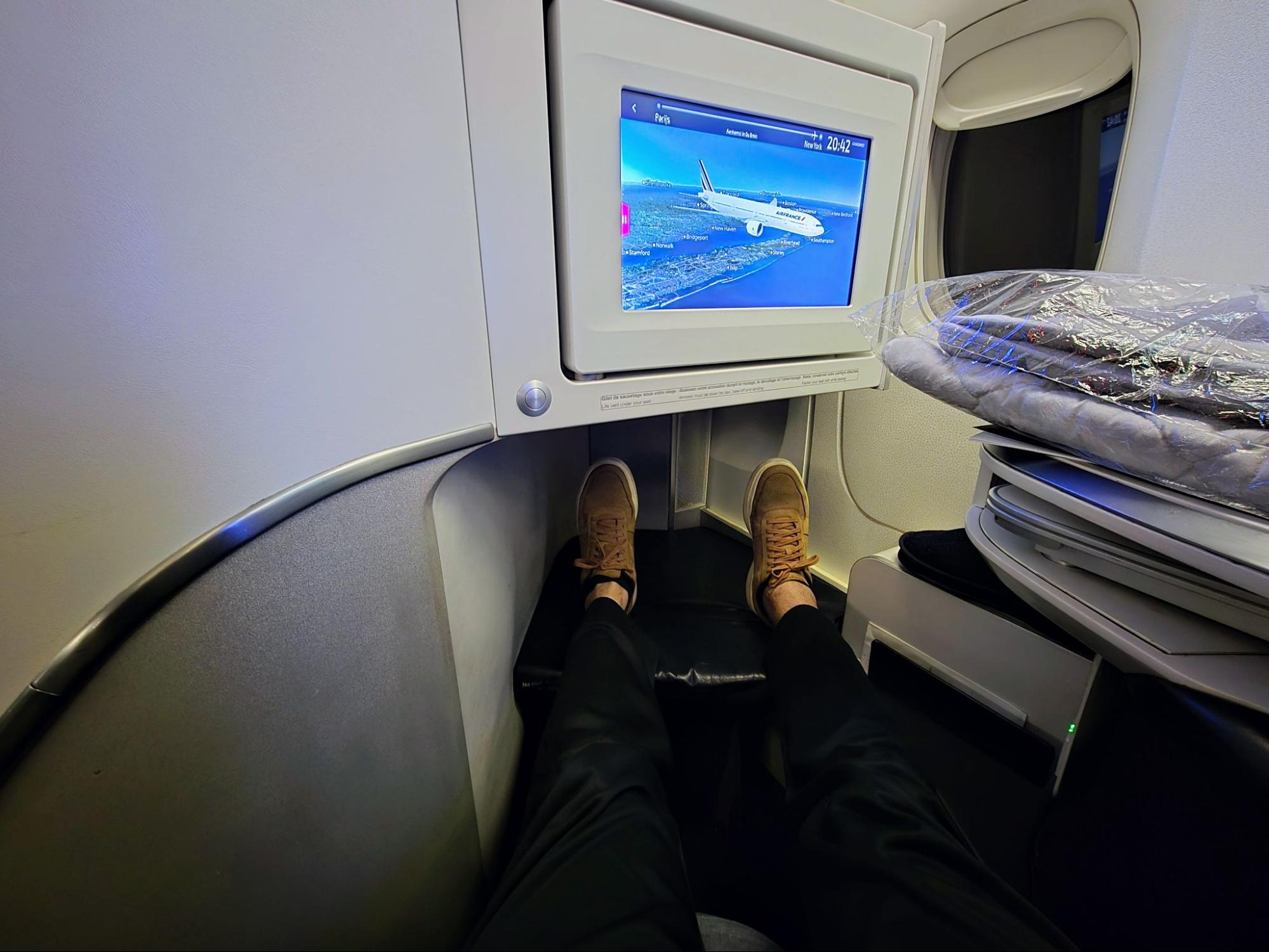 Photo of writer Joseph Hostetler sitting in lie-flat business-class Air France seat.